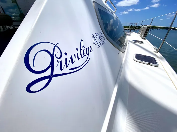 Rock N' No Roll Yacht Photos Pics Privilege 435 yacht, 2006 model, docked under clear blue sky.