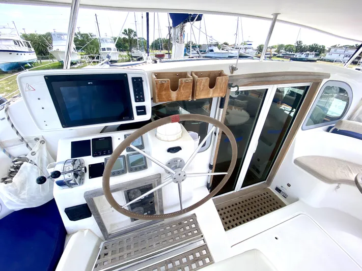Rock N' No Roll Yacht Photos Pics Steering area of a 2006 Privilege 435 yacht with navigation equipment.