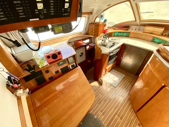 Rock N' No Roll Yacht Photos Pics Interior of 2006 Privilege 435 yacht with wooden finishes and modern kitchen amenities.