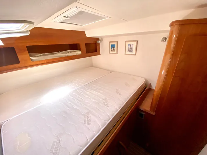 Rock N' No Roll Yacht Photos Pics Cozy cabin interior of 2006 Privilege 435 yacht with wooden accents and double bed.