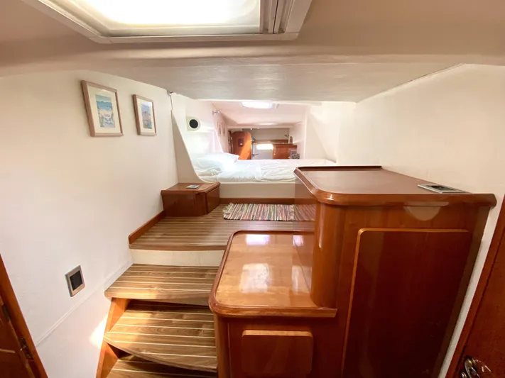 Rock N' No Roll Yacht Photos Pics Luxurious 2006 Privilege 435 yacht interior with wooden steps and cozy bedroom.