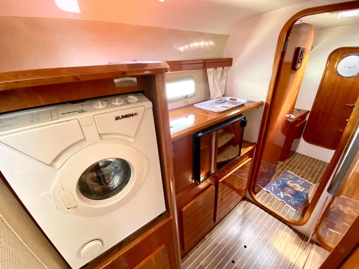 Rock N' No Roll Yacht Photos Pics Interior of 2006 Privilege 435 yacht with washing machine and wooden cabinetry.