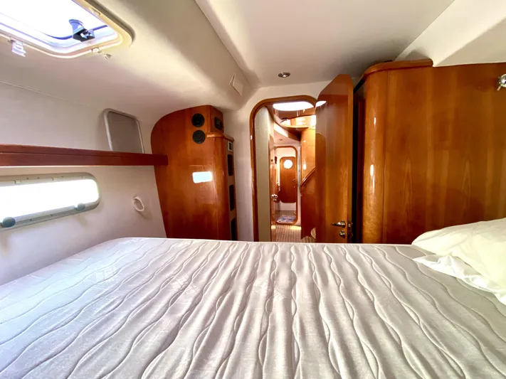 Rock N' No Roll Yacht Photos Pics Luxurious cabin interior of 2006 Privilege 435 yacht with wooden finishes and cozy bedding.