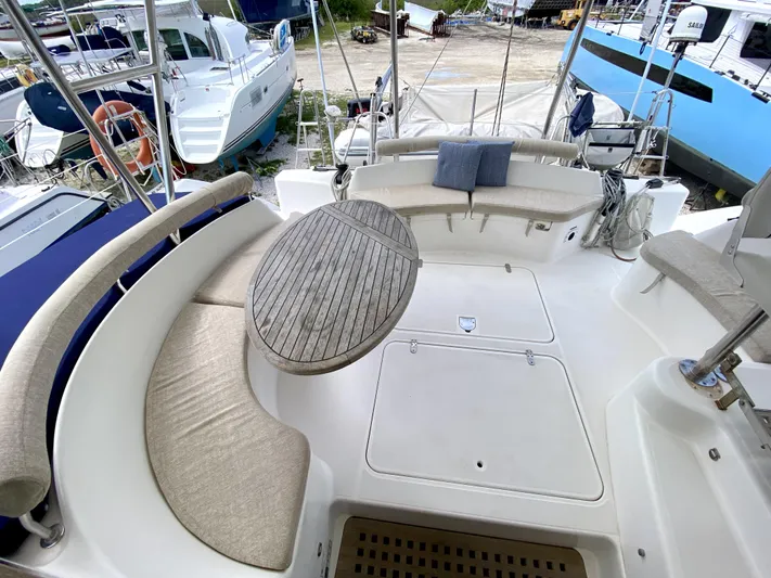 Rock N' No Roll Yacht Photos Pics Spacious deck of 2006 Privilege 435 yacht with cushioned seating and wooden table.