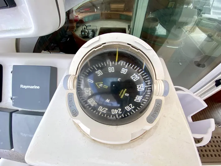 Rock N' No Roll Yacht Photos Pics Compass on 2006 Privilege 435 yacht, with Raymarine equipment visible nearby.
