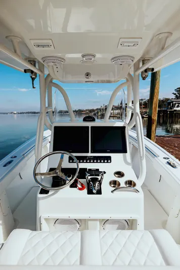  Yacht Photos Pics 2006 Yellowfin 31 CC boat cockpit with dual screens and steering wheel.
