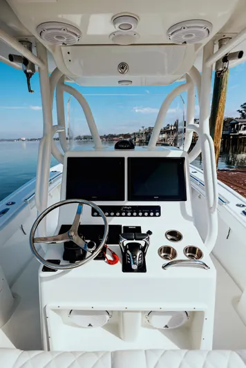 Yacht Photos Pics 2006 Yellowfin 31 CC boat console with dual screens and steering wheel.