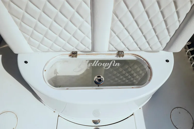  Yacht Photos Pics 2006 Yellowfin 31 CC boat with white quilted seating and storage compartment.