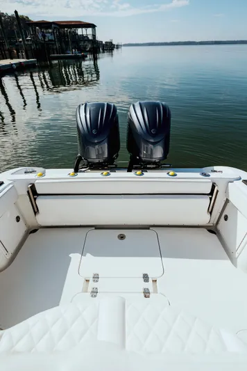  Yacht Photos Pics 2006 Yellowfin 31 CC boat with dual engines on calm water.