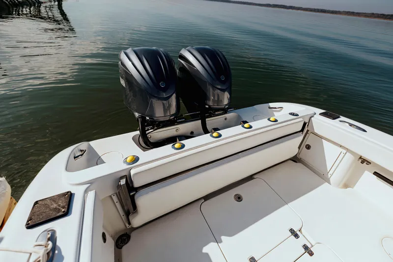  Yacht Photos Pics 2006 Yellowfin 31 CC boat with dual outboard motors on calm water.