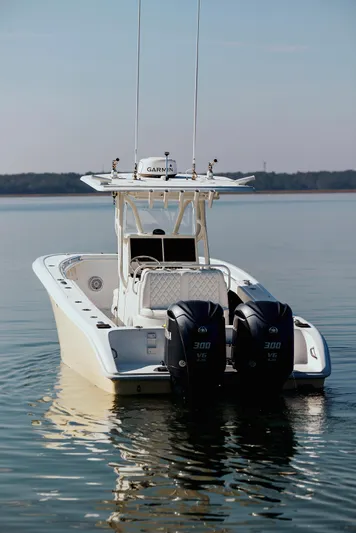  Yacht Photos Pics 2006 Yellowfin 31 CC boat with dual engines on calm water.