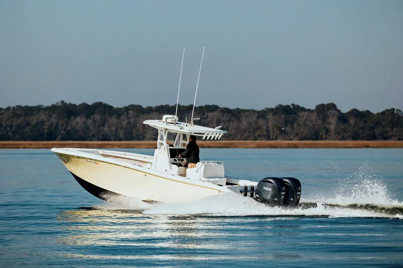  Yacht Photos Pics 2006 Yellowfin 31 CC boat cruising on calm water with twin outboard engines.