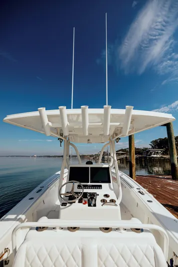  Yacht Photos Pics 2006 Yellowfin 31 CC boat docked, featuring a sleek console and clear blue sky backdrop.