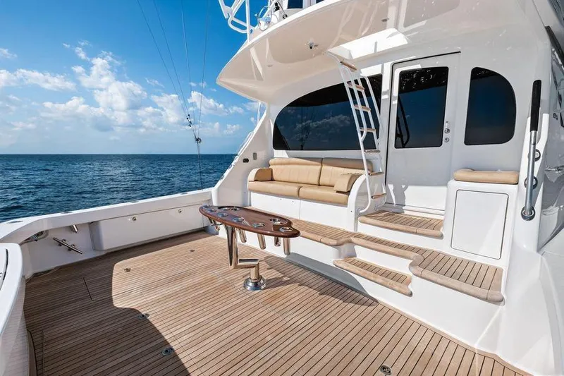 Sexy Lady Yacht Photos Pics Luxurious 2017 Viking 62 Convertible yacht deck with seating, ocean view, and clear skies.