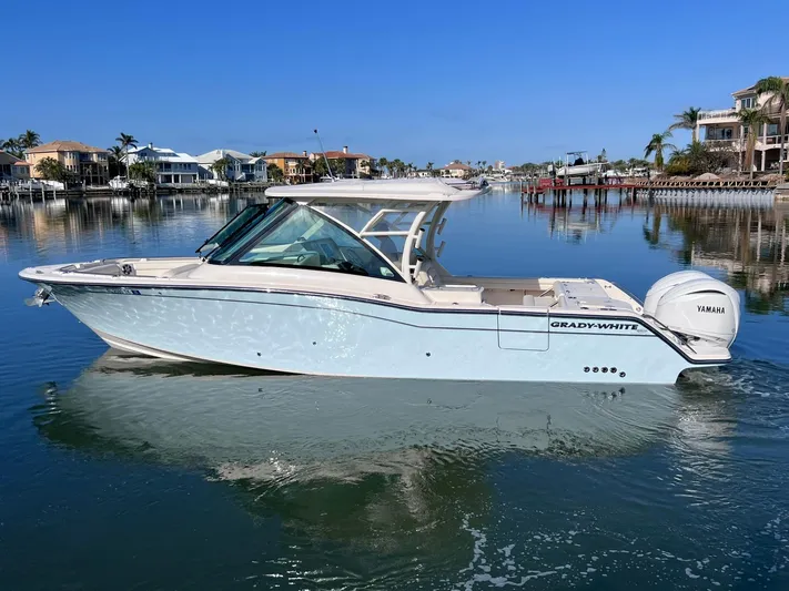  Yacht Photos Pics 2023 Grady-White Freedom 325 boat on calm water, showcasing sleek design and luxury features.
