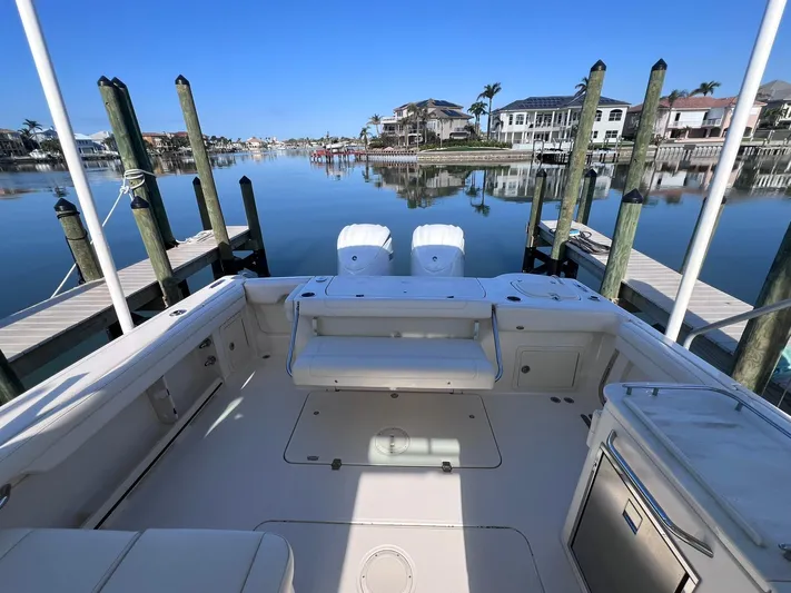  Yacht Photos Pics 2023 Grady-White Freedom 325 boat docked in a serene marina setting.