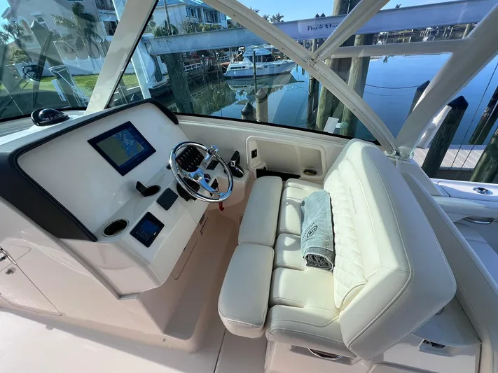 Yacht Photos Pics 2023 Grady-White Freedom 325 boat interior with helm and seating area.