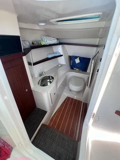  Yacht Photos Pics 2023 Grady-White Freedom 325 boat interior with compact bathroom and sink.