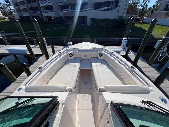  Yacht Photos Pics 2023 Grady-White Freedom 325 boat docked, showcasing spacious seating and sleek design.