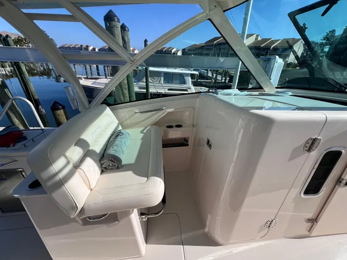  Yacht Photos Pics 2023 Grady-White Freedom 325 boat interior with seating and helm station.