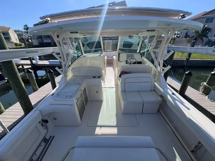  Yacht Photos Pics 2023 Grady-White Freedom 325 boat interior with seating and helm, docked at marina.