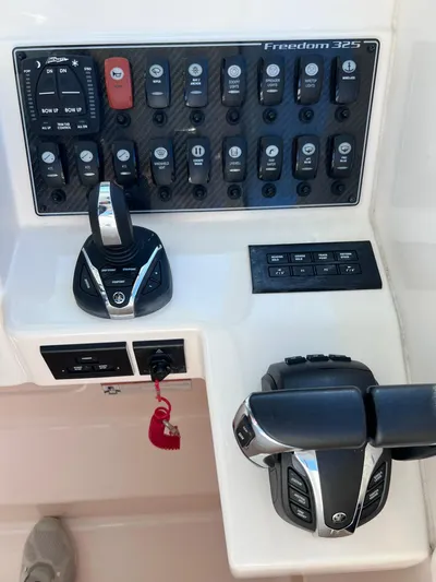  Yacht Photos Pics 2023 Grady-White Freedom 325 boat control panel with switches and throttle levers.
