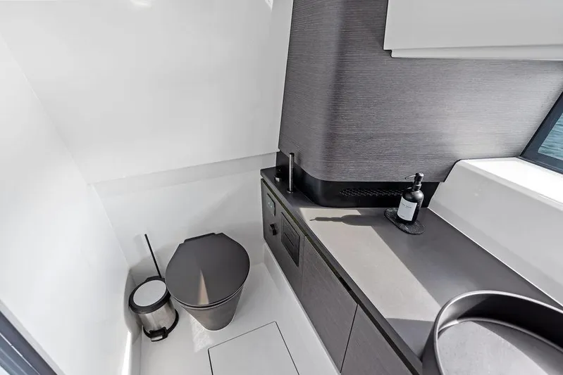 Mako Yacht Photos Pics Modern bathroom interior on 2024 Maori M46 yacht, featuring sleek design and compact layout.