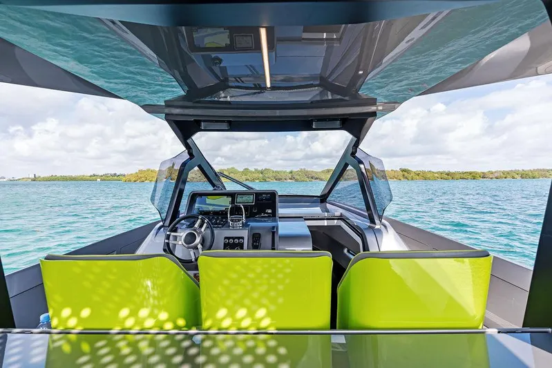 Mako Yacht Photos Pics 2024 Maori M46 yacht cockpit with vibrant green seats and modern controls on open water.