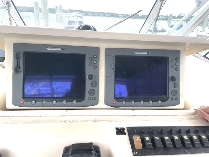 Working Girl Yacht Photos Pics 2008 Grady-White Open Express boat dashboard with dual navigation screens and control panel.