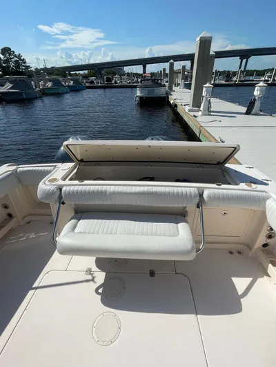 Working Girl Yacht Photos Pics 2008 Grady-White Open Express boat at marina dock, featuring open seating area.