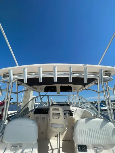 Working Girl Yacht Photos Pics 2008 Grady-White Open Express boat interior with helm and seating under clear blue sky.