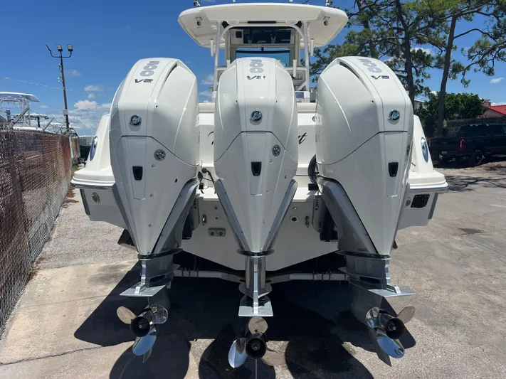  Yacht Photos Pics 2017 Boston Whaler 350 Outrage with triple V8 engines, docked outdoors.