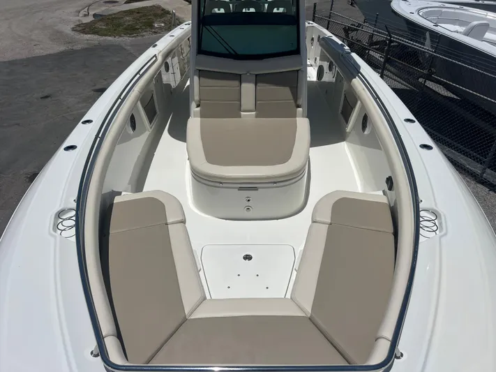  Yacht Photos Pics 2017 Boston Whaler 350 Outrage boat interior with beige seating and spacious deck.