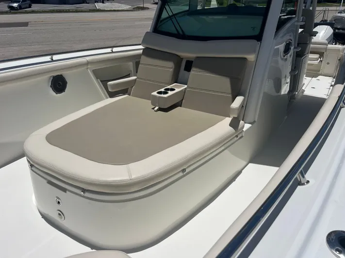  Yacht Photos Pics 2017 Boston Whaler 350 Outrage boat interior with cushioned seating and cup holders.