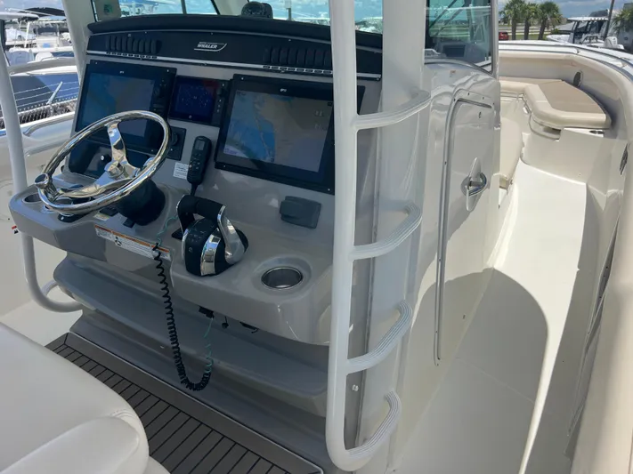  Yacht Photos Pics 2017 Boston Whaler 350 Outrage helm with dual screens and steering wheel.