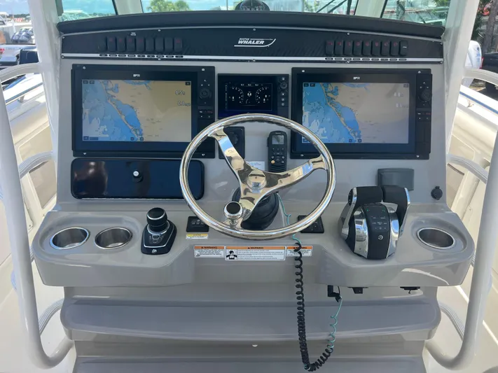  Yacht Photos Pics 2017 Boston Whaler 350 Outrage helm with dual navigation screens and steering wheel.