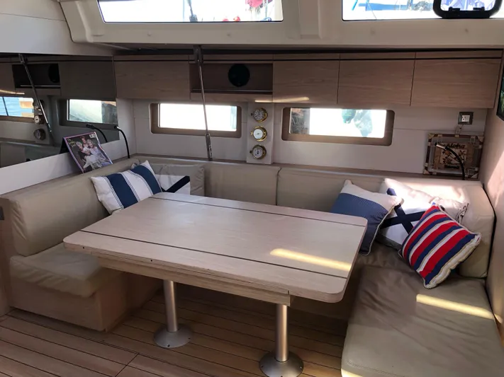 Hydrobaby3 Yacht Photos Pics Interior of 2019 Beneteau Oceanis 51.1 yacht with cozy seating and nautical decor.