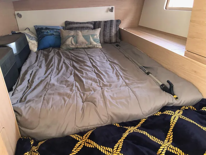 Hydrobaby3 Yacht Photos Pics Cozy cabin interior of 2019 Beneteau Oceanis 51.1 with plush bedding and nautical-themed pillows.