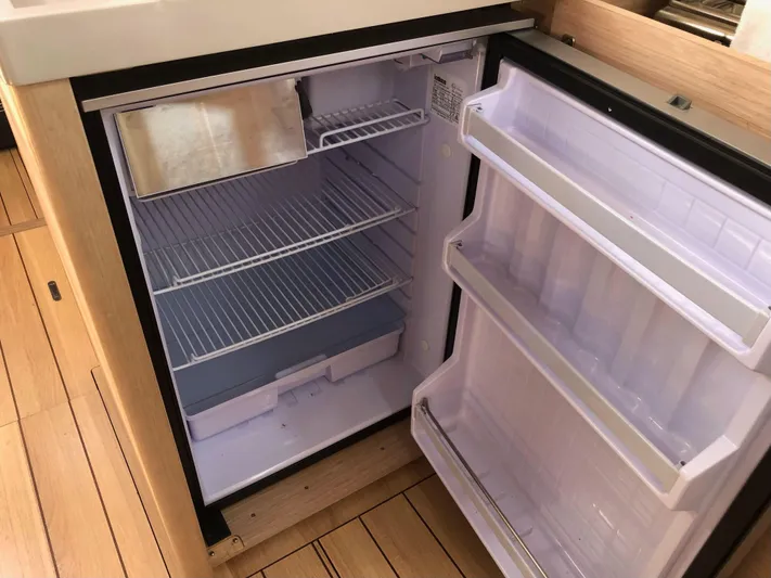 Hydrobaby3 Yacht Photos Pics Refrigerator inside 2019 Beneteau Oceanis 51.1 yacht, featuring spacious shelving and door compartments.