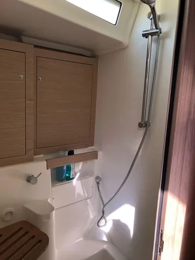Hydrobaby3 Yacht Photos Pics 2019 Beneteau Oceanis 51.1 yacht bathroom with shower and wooden cabinets.