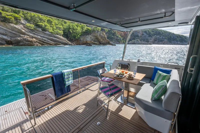  Yacht Photos Pics 2025 Beneteau Swift Trawler 54, elegant deck dining with scenic ocean view.