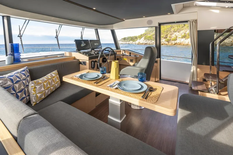  Yacht Photos Pics Interior of 2025 Beneteau Swift Trawler 54 with elegant dining area and ocean view.