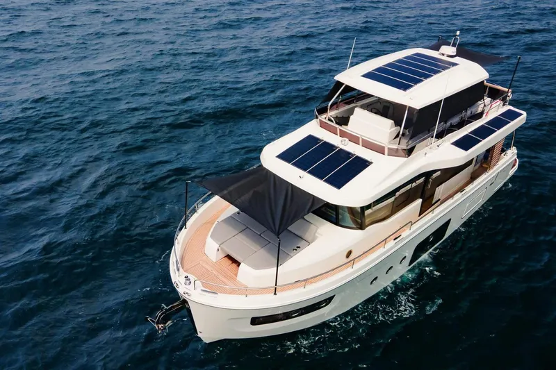  Yacht Photos Pics 2025 Beneteau Swift Trawler 54 cruising on open sea with solar panels.
