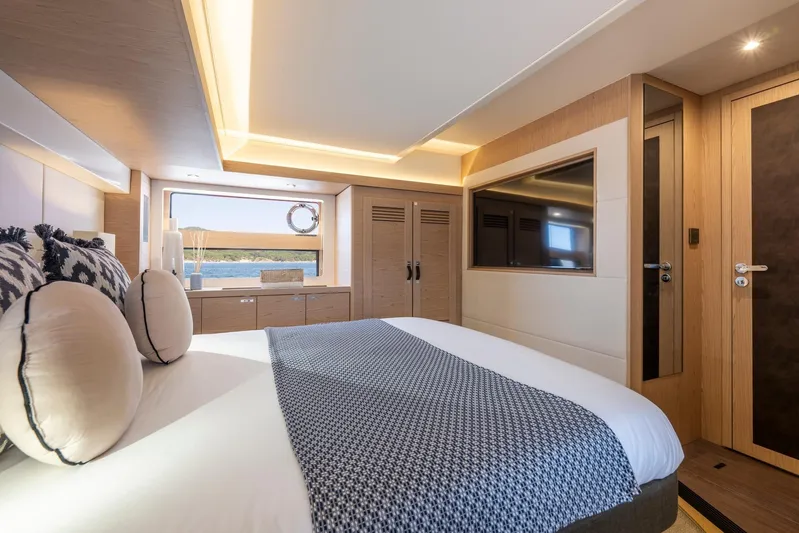  Yacht Photos Pics Luxurious bedroom interior of 2025 Beneteau Swift Trawler 54, featuring modern design and elegant decor.