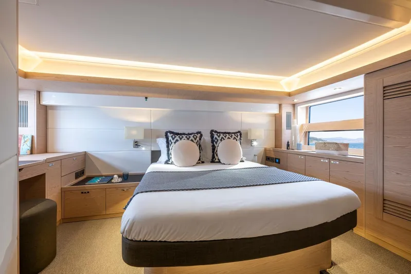  Yacht Photos Pics Luxurious bedroom interior of 2025 Beneteau Swift Trawler 54 yacht, featuring modern design.