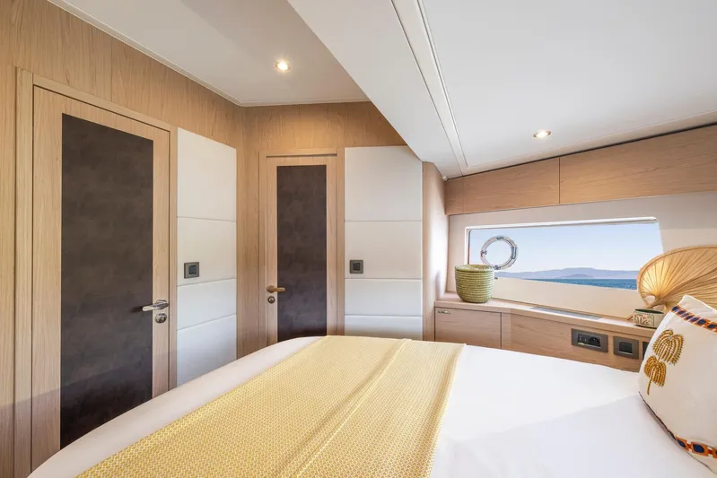  Yacht Photos Pics Luxurious bedroom interior of 2025 Beneteau Swift Trawler 54, featuring elegant wood finishes.