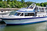1990 Trader 41 + 2 Sundeck yacht docked, featuring sleek design and spacious sundeck.