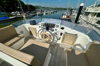 1990 Trader 41 + 2 Sundeck yacht helm with beige seating, docked in a marina.
