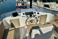 1990 Trader 41 + 2 Sundeck yacht helm with wooden wheel and navigation equipment.