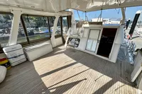 Spacious sundeck of 1990 Trader 41 + 2 Sundeck yacht with wooden flooring.